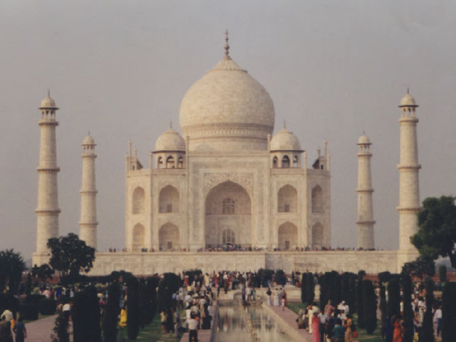 Photograph taken by Helen Murray of the Taj Mahal in Agra, India with people in the foreground, from 2001