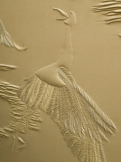 Detail of hand-sculpted gold faux suede artwork by Helen Amy Murray featuring cranes and clouds in a gold wooden frame