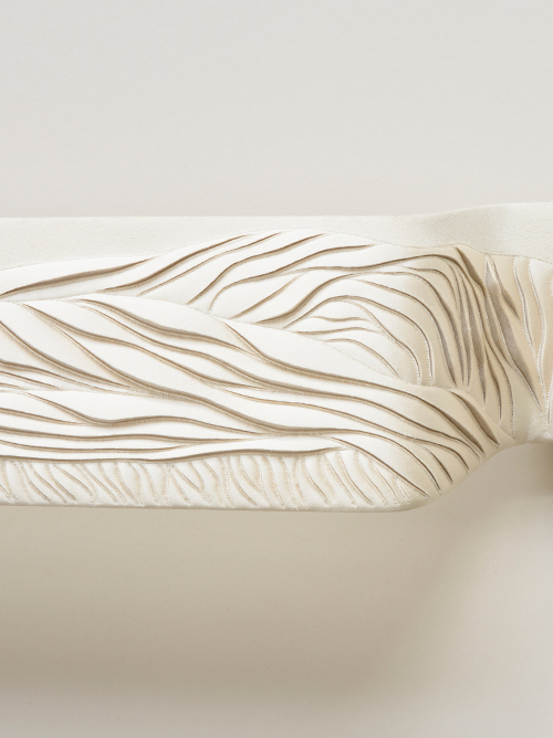 Detail of hand-sculpted artwork by Helen Amy Murray in off-white faux suede with cream silk crepe satin appliqué