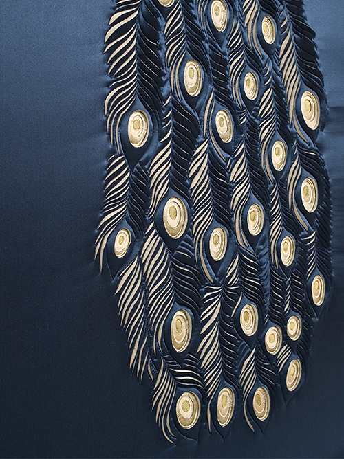 Artwork showing detail of Peacock's tail feathers, hand-sculpted in navy and gold silk crepe satin and douppion silk appliqué