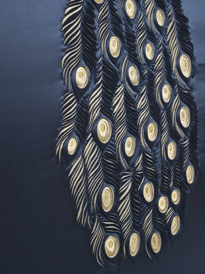Artwork showing detail of Peacock's tail feathers, hand-sculpted in navy and gold silk crepe satin and douppion silk appliqué