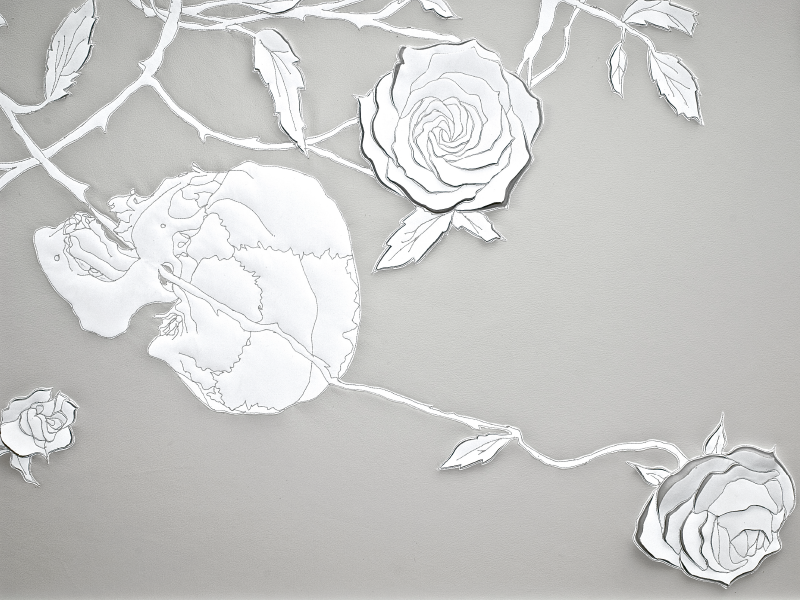 Detail of artwork of twisting branches and leaves, in white vegetable tanned leather and reflective white fabric appliqué