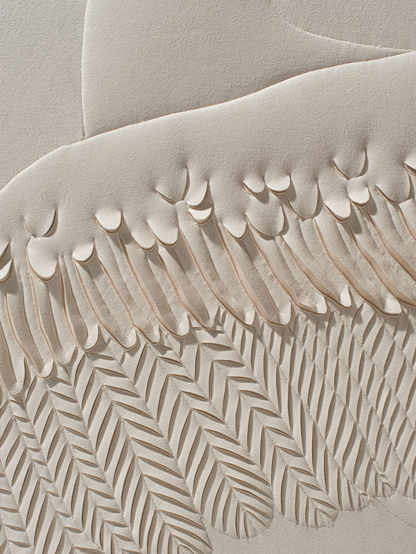 Detail of a hand-sculpted artwork by Helen Amy Murray of a swan showing wing feathers and neck in a cream colour faux suede