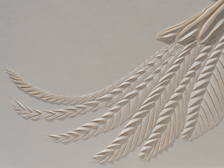Detail of a hand-sculpted artwork by Helen Amy Murray of a swan showing wing feathers in a cream colour faux suede