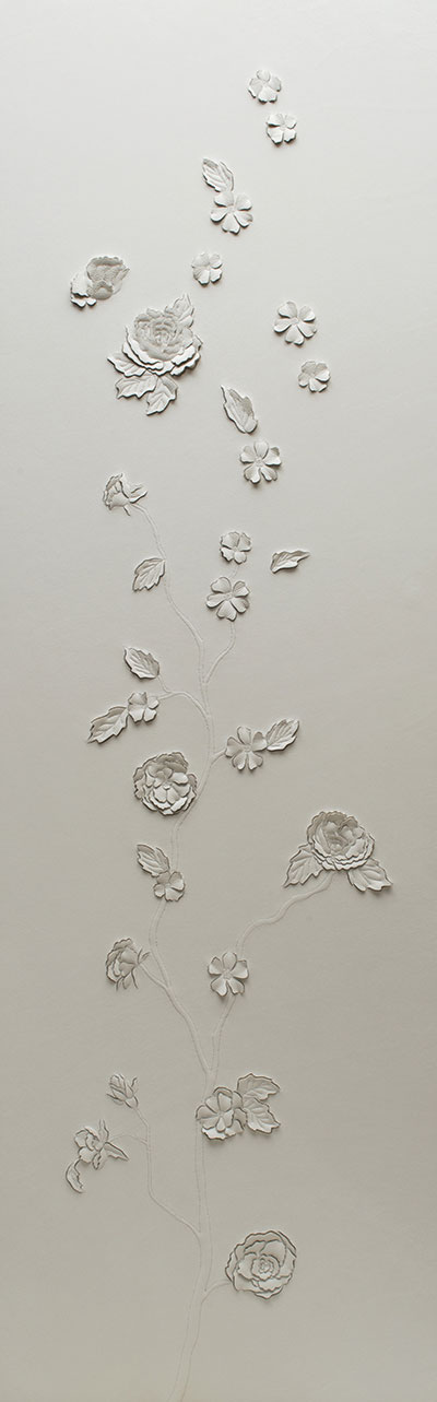 A pair of hand-sculpted white leather artworks by Helen Amy Murray featuring three-dimensional wild roses on a branch